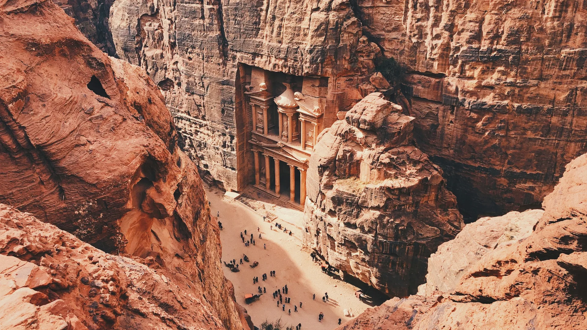 The Treasury (Al-Khazneh) facade carved into the rose-pink cliff at the end of Petra's Siq